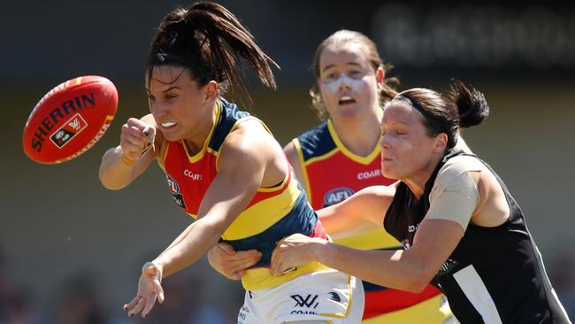 Jessica Sedunary of the Crows is tackled by Stacey Livingstone of the Magpies.