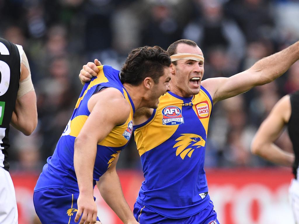 Tom Barrass and Shannon Hurn on the siren in the 2018 grand final. Photo: AAP.