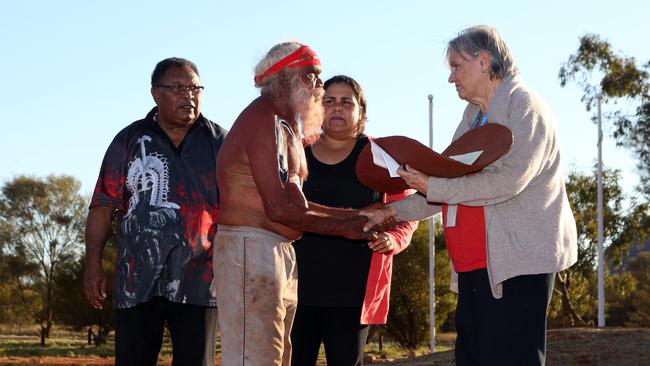 Left to right: Pedro Stephen, Mutitjulu elder Rolley Mintuma, Sally Scales and Pat Anderson being presented a piti holding the Uluru statement, at the closing ceremony of the Indigenous Constitutional Convention held at Mutujulu. Picture: James Croucher