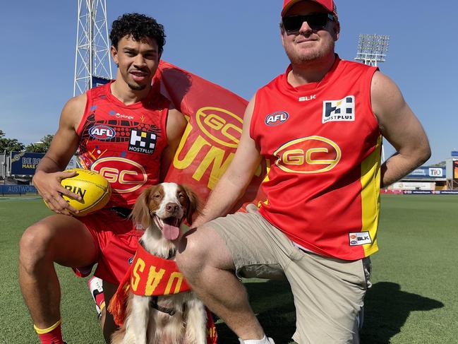 Gold Coast Suns member Justin Rossiter and his dog Milo with Suns player Malcolm Rosas Jr at TIO Stadium. Picture: (A)manda Parkinson