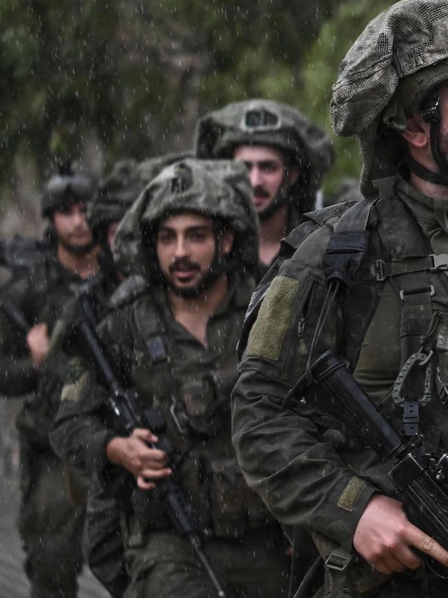 Israeli army soldiers patrol at an undisclosed position in northern Israel near the borer with Lebanon. Picture: AFP