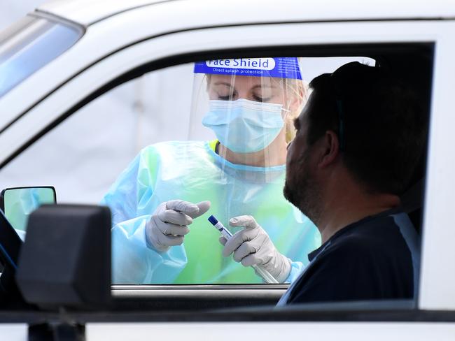 A COVID-19 testing clinic staff member prepares to swab a client in Springfield in Brisbane’s Southwest. Picture: NCA NewWire / Dan Peled