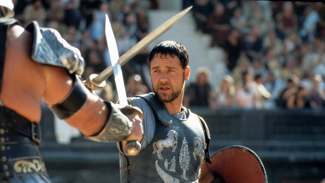 Russell Crowe facing off against another man in a scene from the original Gladiator. (Photo by Universal/Getty Images)