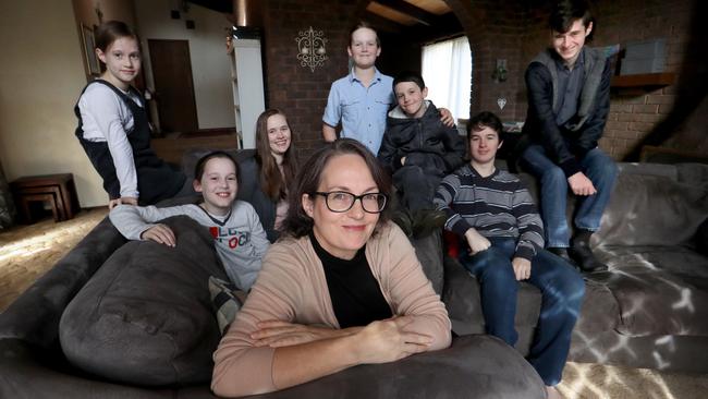 Kathleen Clubb, with her children, from left, Danielle, 7, Miriam, 9, Eva, 14, Tobias, 11, Matthew, 9, Elijah, 17, and Lucien, 16, at their Melbourne home. Picture: David Geraghty