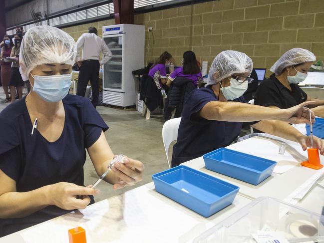 PERTH, AUSTRALIA - APRIL 28: Nurses are seen drawing up doses from a multi-dose vile of AstraZeneca Covid-19 vaccine at Claremont Showgrounds Covid-19 Vaccine Centre on April 28, 2021 in Perth, Australia. The West Australian Government have opened up two new Vaccine Centres including one at Perth Airport. (Photo by Matt Jelonek/Getty Images)