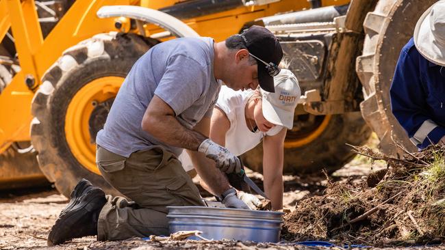 Police sift through the dirt. Picture: Jason Edwards