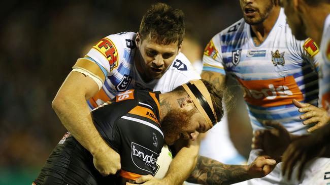 Chris McQueen is tackled by his former Gold Coast teammate Anthony Don. Picture: AAP Image