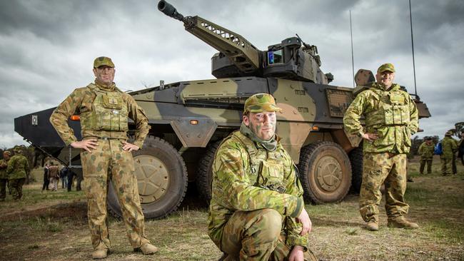 Hard patriotism cannot be solely expected of our armed forces. From left, Sgt James Mathews, Trooper James Sauter and Corporal Christopher Brennan with the Land 400 CRV Boxer. Picture: Mark Stewart