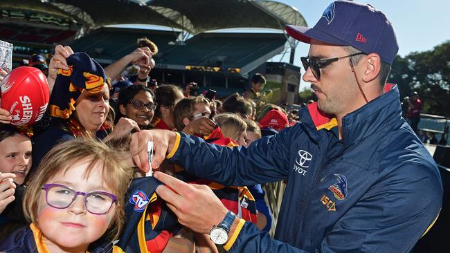 Crows captain Taylor Walker signs autographs for fans at Adelaide Oval yesterday at the club’s family day following the team’s return from Melbourne. Picture: Tom Huntley.