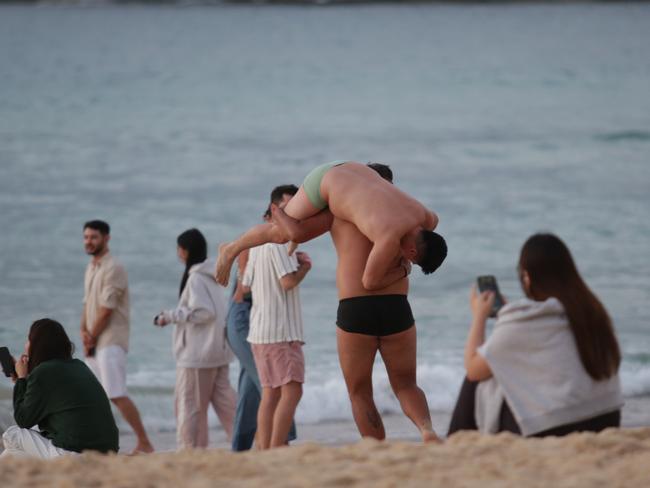 SYDNEY, AUSTRALIA - NewsWire Photos - 01 JANUARY, 2025:Early morning sunrise coverage from Sydney's iconic Bondi Beach as the first day of 2025 rings in with revellers from New Years Eve still enjoying festivities as dawn breaks.Picture: NewsWire / Christian Gilles