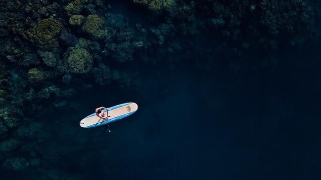 Paddle boarder at Walindi Plantation Resort.