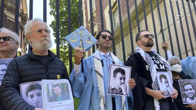 Mohsen Mahdawi, center, holds a photo of Mahmoud Khalil outside the gates of Columbia University after graduating this month. Picture: AP /Jake Offenhartz