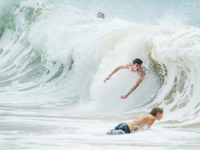 A Body surfer flies down a wave at Moffat Beach. Strong winds and large swell has arrived on the Sunshine coast as Cyclone Oma continues to track towards South East Queensland. Photo Lachie Millard