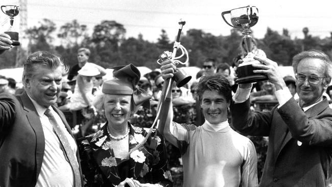 Kingston Rule's trainer Bart Cummings, jockey Darren Beadman and owners Helen and David Hains celebrate after thoroughbred Kingston Rule won 1990 Melbourne Cup. The Hains’ 162ha property on the Mornington Peninsula, formerly home to victor Kingston Rule and other champion racehorses, is expected to fetch about $50m.