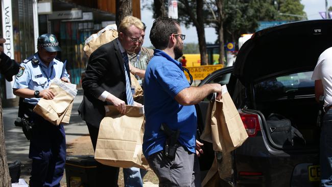 Police remove evidence from a unit at Australia Ave in Sydney Olympic Park. Picture: Craig Wilson