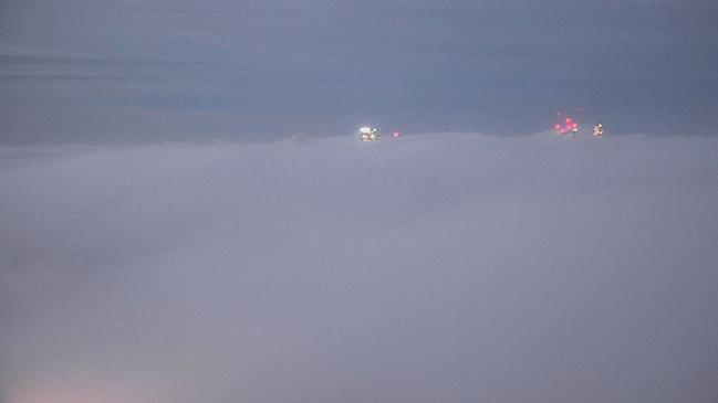 Shot from Nine's rooftop camera shows a thick blanket of fog over Sydney skyline. Picture: Nine