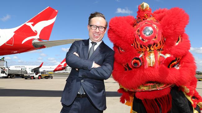 ‘We are very proud to be back in Beijing’: Qantas chief executive Alan Joyce with a dragon friend on the tarmac at Sydney Airport yesterday. Picture Renee Nowytarger
