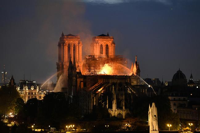 Firefighters douse flames rising from the roof of Notre-Dame Cathedral in Paris on April 15. Picture: Bertrand Guay, AFP