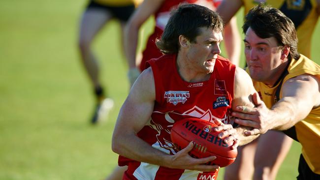 League Best &amp; Fairest Brett O’Neil (South Gambier) tries to break away from North Gambier Legend Scott Flett. Picture: Frank Monger