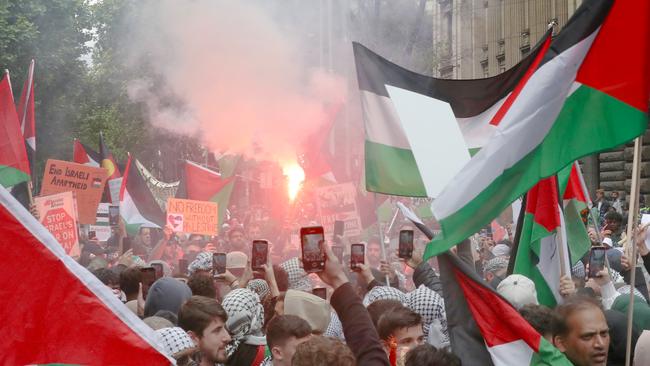 People participate in a rally against the occupation of Palestine and the conflict between Israel and Hamas in Melbourne CBD. One flare was set off during the march in October. Picture: David Crosling