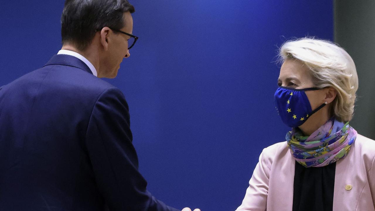 Awkward. Poland's Prime Minister Mateusz Morawiecki (L) and European Commission President Ursula von der Leyen shake hands in Brussels on October 21. (Photo by YVES HERMAN / POOL / AFP)