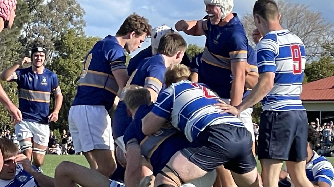 Churchie's Connor Simpson is dragged to his feet after scoring.