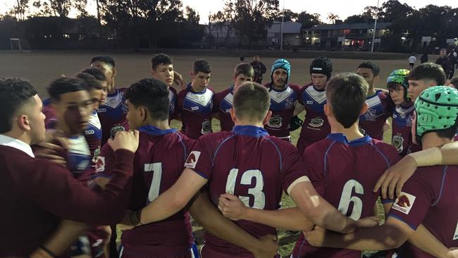 Langer Trophy player Jayden Smith, far left, is welcomed into the Wavell SHS Walters Cup huddle before the match..