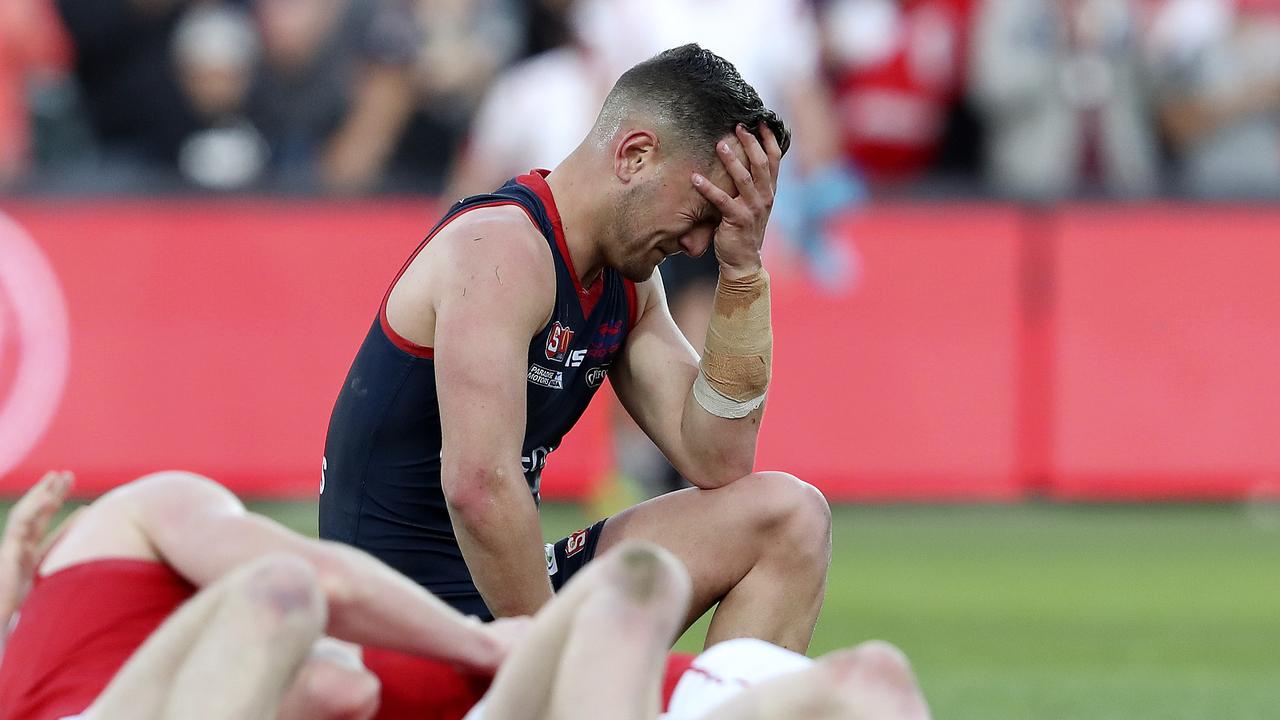 23/09/18 - SANFL - Grand Final - Norwood v North Adelaide at the Adelaide Oval. Matthew Nunn slumps on the siren and the loss while NOrth players start to celebrate. Picture SARAH REED