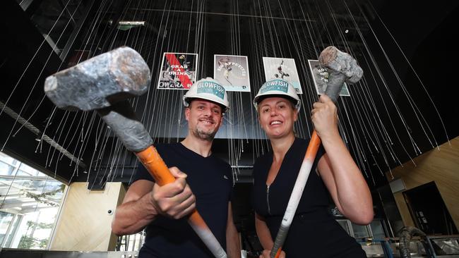 Broadbeach Moo Moo owners Steven and Autumn Adams are taking over the empty space which used to house The Bavarian at the Oracle. It will be the first two storey restaurant in the area. The pair get to work. Picture Glenn Hampson