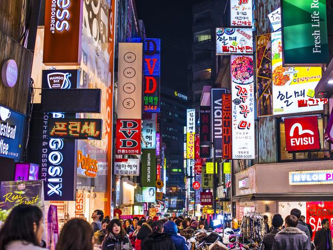 Seoul, South Korea. Crowds pass under the Myeong-Dong neon lights. The location is the premiere district for shopping in the city.Photo - istockEscape 26 March 2023Seoul