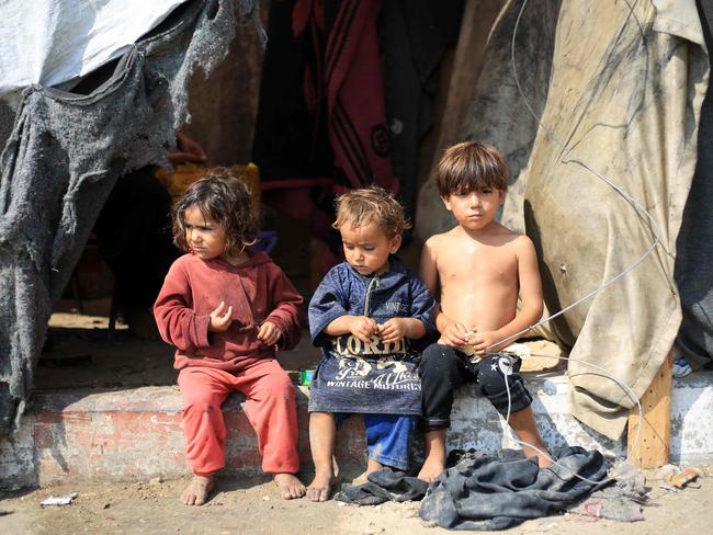 Displaced Palestinian children sit in front of a tent used as temporary shelter in Deir el-Balah in the central Gaza Strip on July 7, 2024. Picture: AFP