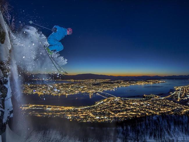 Arctic Urban Skiing ... A friend skiing at night, descends a 10 meter high clifftop in Tromso, Norway. The challenge was quite demanding because the night was much darker than it appears in the photo. So much so, that it was impossible to see where one might land. The image is the result of a long exposure and the use of a specific flash pointed to capture the subject during action. Location: Tromsø, Norway. Picture: Audun Rikardsen (NO)/Siena International Photo Awards 2016