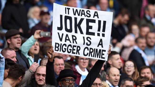 A fan holds a sign criticising VAR ahead of the English Premier League football match between Manchester City and Wolverhampton Wanderers at the Etihad Stadium in Manchester, north west England, on October 6. Picture: Oli Scarff/AFP