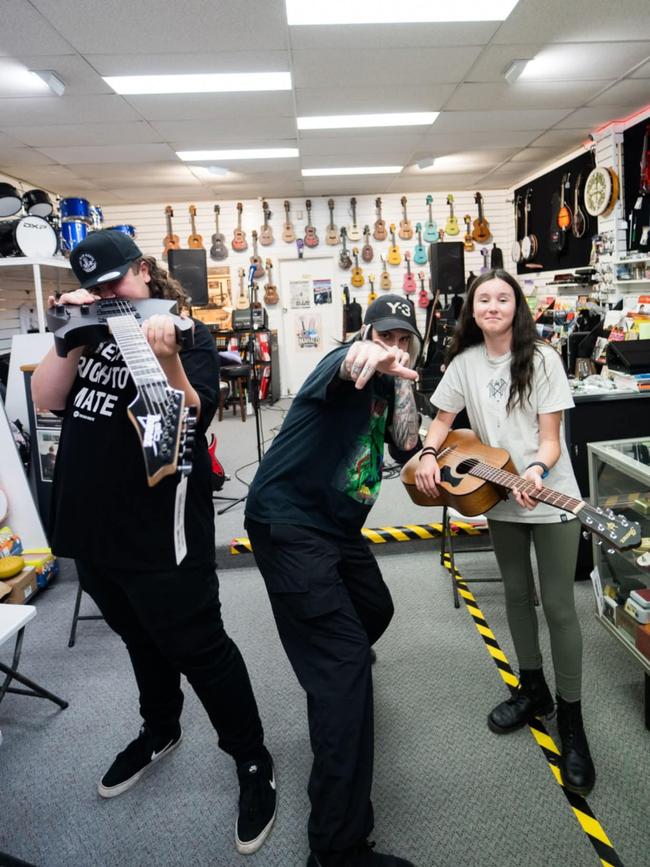 Gram Taylor, Alpha Wolf's Sabian Lynch and 11-year-old Alexis Clousen at Fosters Musics Burnie. Picture: Supplied