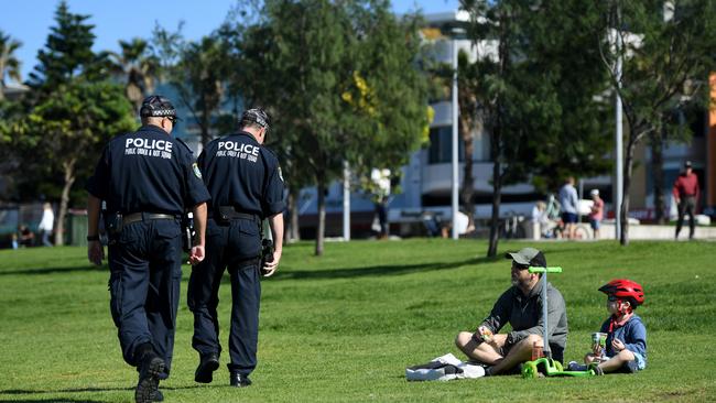 NSW Police ask people to move on while patrolling Bondi Beach during the Easter Long Weekend. Picture: AAP Joel Carrett