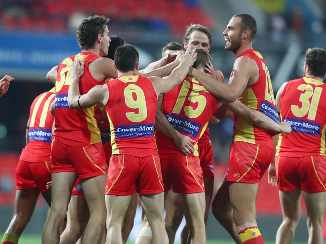 Aaron Young of the Suns celebrates a goal with team mates during the round 23 AFL match between the Gold Coast Suns and the Greater Western Sydney Giants at Metricon Stadium on August 24, 2019 in Gold Coast, Australia. (Photo by Chris Hyde/Getty Images)