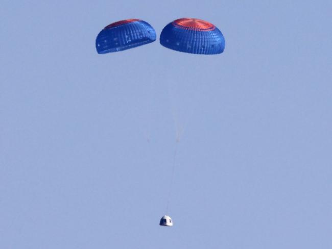 Blue Origin’s New Shepard crew capsule descends on the end of its parachute system carrying 90-year-old Star Trek actor William Shatner and three other civilians. Picture: AFP