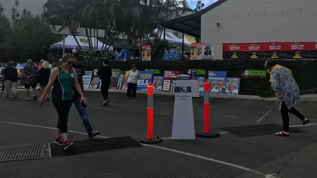 Booth workers lag out mats on the awkward bump that claimed the dignity of a handful of Moncrieff voters. Picture: Kirstin Payne.