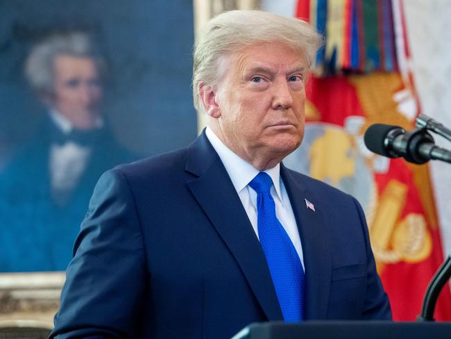 (FILES) In this file photo taken on December 7, 2020 US President Donald Trump looks on during a ceremony presenting the Presidential Medal of Freedom to wrestler Dan Gable in the Oval Office of the White House in Washington, DC. - Former president Donald Trump will not testify in his Senate impeachment trial next week, an advisor said on February 4, 2021, after House prosecutors called on him to appear for questioning. (Photo by SAUL LOEB / AFP)