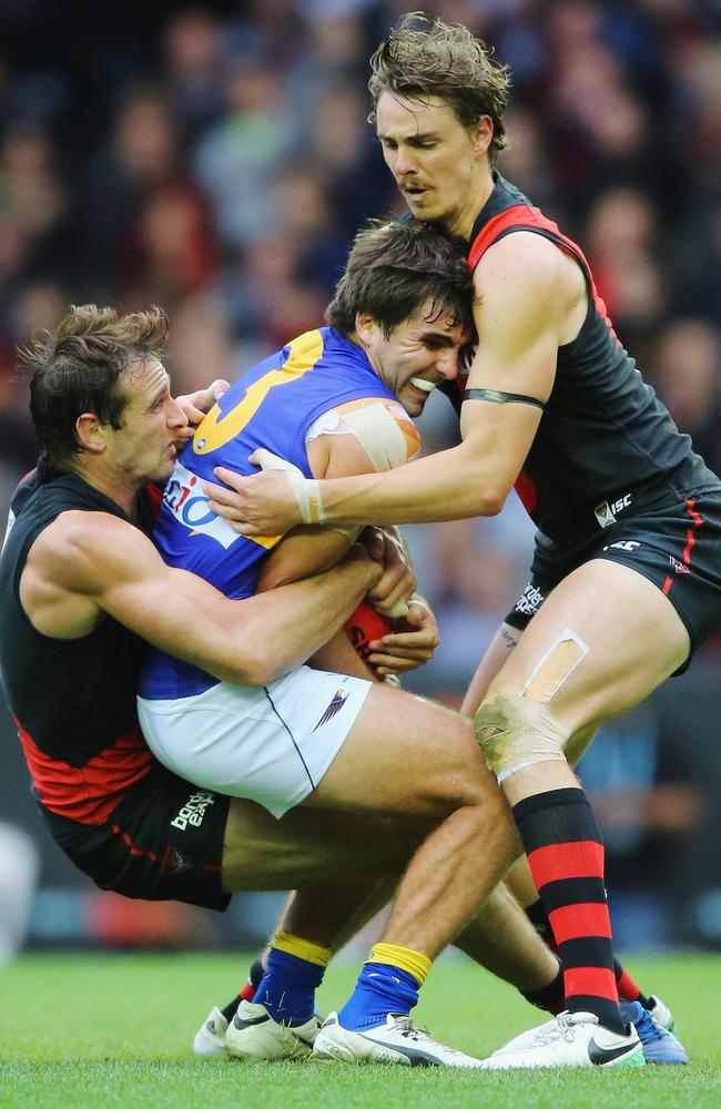 Jobe Watson and Joe Daniher wrap up Eagle Andrew Gaff.