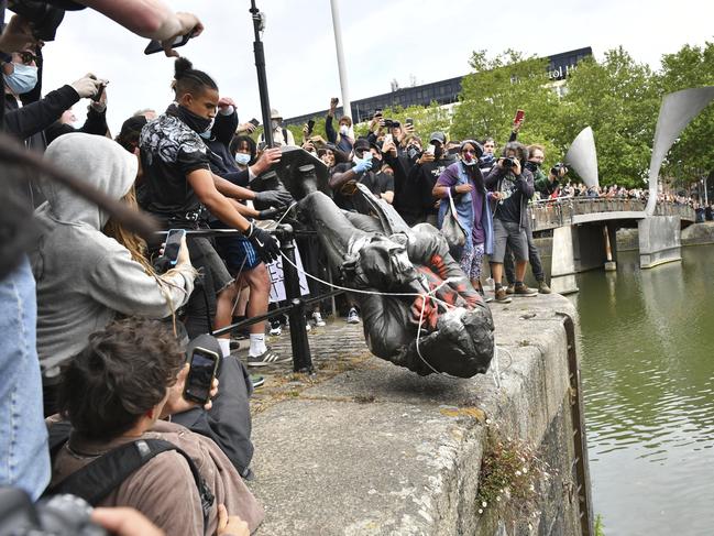 Protesters throw a statue of slave trader Edward Colston into Bristol harbour. Picture: AP