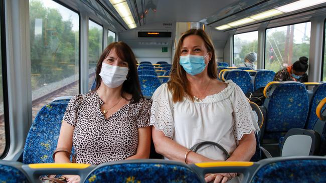 Julie Roberts and Megan Louise wearing masks on the train to Central. Picture: Justin Lloyd