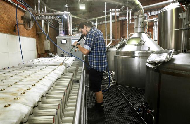 Brewer Andre Keller hoses out the filters. Picture: John Appleyard