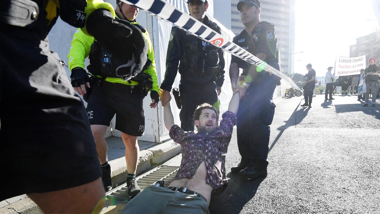 An Extinction Rebellion protester is being arrested in Brisbane. Picture: AAP Image/Dan Peled