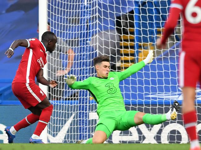 Liverpool's Senegalese striker Sadio Mane (L) scores their second goal past Chelsea's Spanish goalkeeper Kepa Arrizabalaga during the English Premier League football match between Chelsea and Liverpool at Stamford Bridge in London on September 20, 2020. (Photo by NEIL HALL / POOL / AFP) / RESTRICTED TO EDITORIAL USE. No use with unauthorized audio, video, data, fixture lists, club/league logos or 'live' services. Online in-match use limited to 120 images. An additional 40 images may be used in extra time. No video emulation. Social media in-match use limited to 120 images. An additional 40 images may be used in extra time. No use in betting publications, games or single club/league/player publications. /