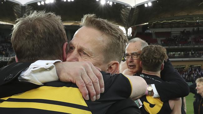 Glenelg President Nick Chigwidden hugs coach Mark Stone after the 2019 SANFL grand final win – with club legend Peter Carey in background. Picture: Sarah Reed