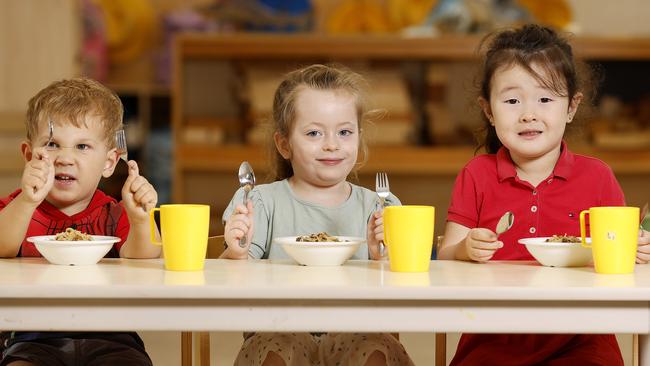 Charlie, 3, Isabella, 4, and Skye, 4, with their chef-prepared meal at C&amp;K Kedron childcare centre. Picture: Josh Woning