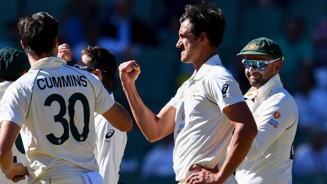 Australiaâs Mitchell Starc (2nd R) celebrates with teammates after dismissing Indiaâs Mayan Agarwal (not pictured) on the first day of the second cricket Test match between Australia and India played at the MCG in Melbourne on December 26, 2020. (Photo by William WEST / AFP) / -- IMAGE RESTRICTED TO EDITORIAL USE - STRICTLY NO COMMERCIAL USE --