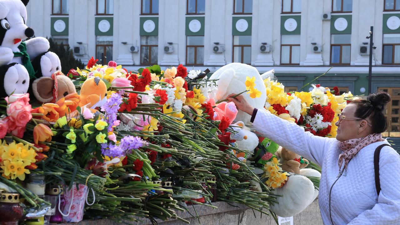 A woman lays flowers at a makeshift memorial in Simferopol, Crimea, as Russia observes a national day of mourning after a massacre in the Crocus City Hall that killed more than 130 people. Picture: AFP