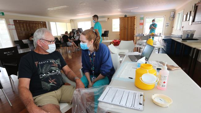 Gold Coast vaccination hubs, The Southport SLSC. Nurse Cat Donald with Southport Resident Mr Warren Mansell Chard getting his vaccination. Pic Mike Batterham
